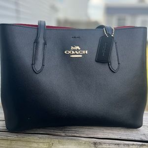 Solid black with red interior Coach tote